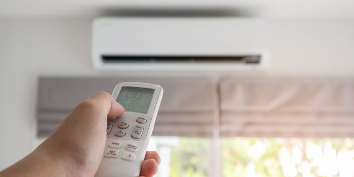 HVAC technician inspecting an air conditioner that is running but not cooling properly during a residential service call | Air Conditioner Is Running But Not Cooling