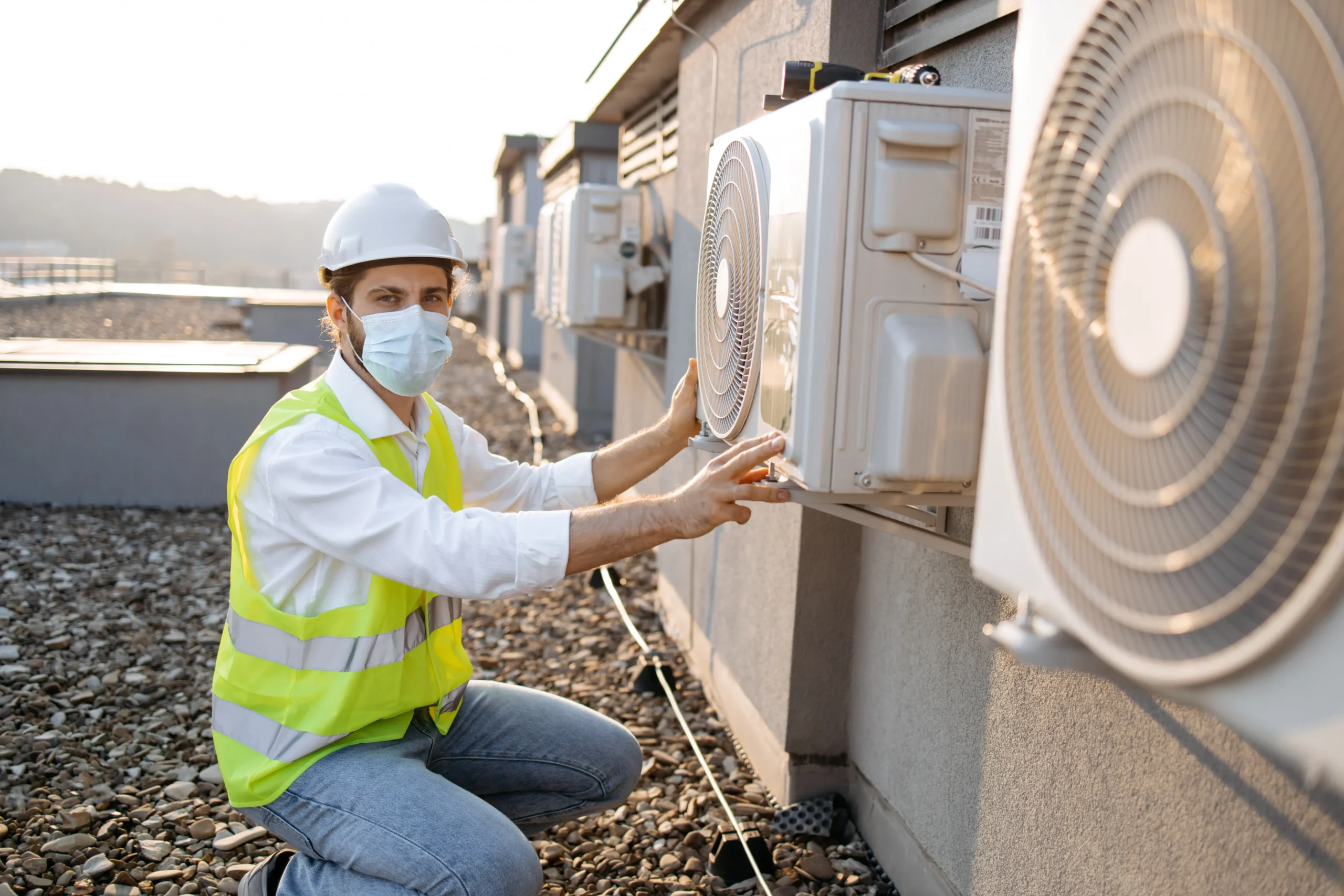 A technician checking the HVAC for maintenance.